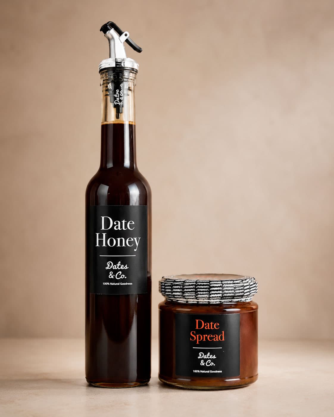 Bottle of Dates & Co date honey beside a jar of date spread