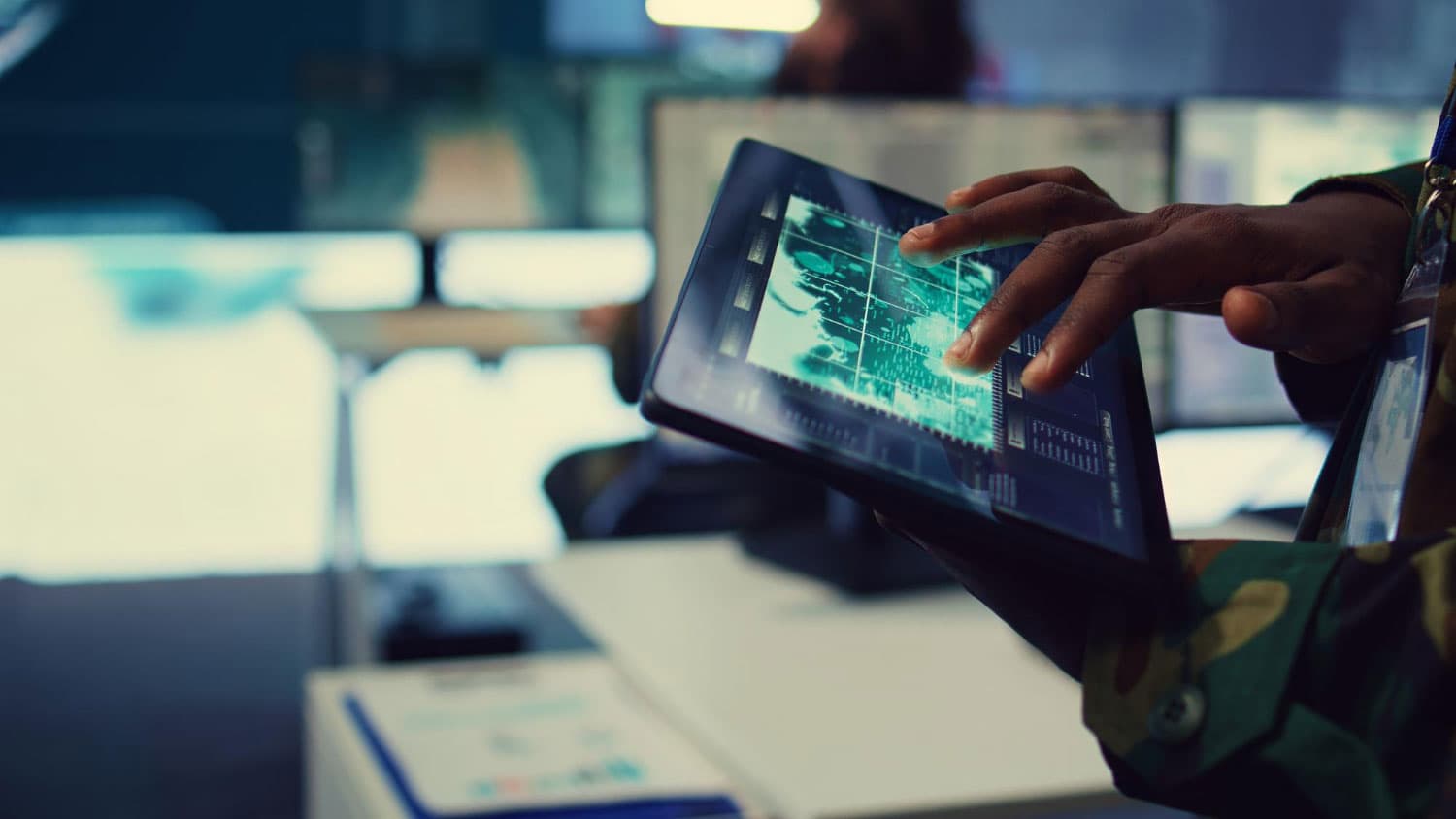 Hand using a tablet to review operational data